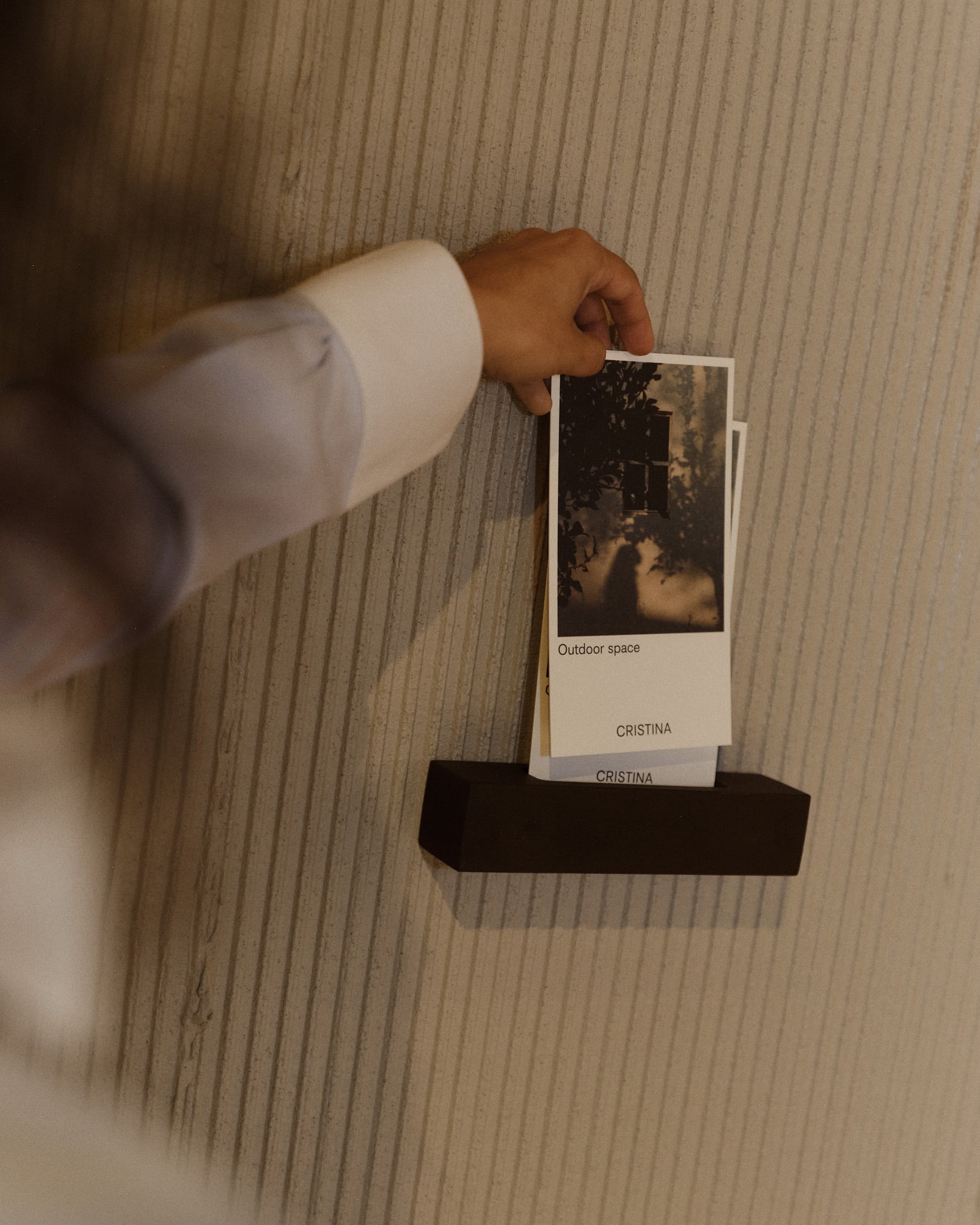 A hand taking an information card detailing an outdoor space